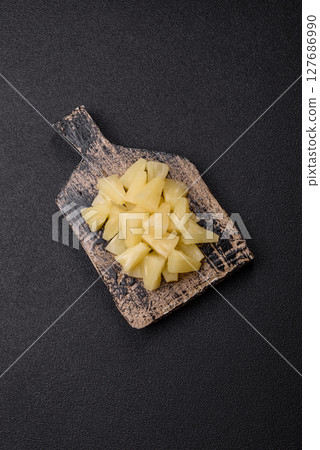 Tropical sweet tinned pineapple fruit sliced into slices Tropical sweet tinned pineapple fruit sliced into slices 127686990