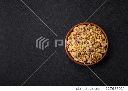 Flakes, chocolate balls and dried fruit for a hearty breakfast Flakes, chocolate balls and dried fruit for a hearty breakfast 127687021