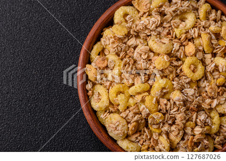 Flakes, chocolate balls and dried fruit for a hearty breakfast Flakes, chocolate balls and dried fruit for a hearty breakfast 127687026