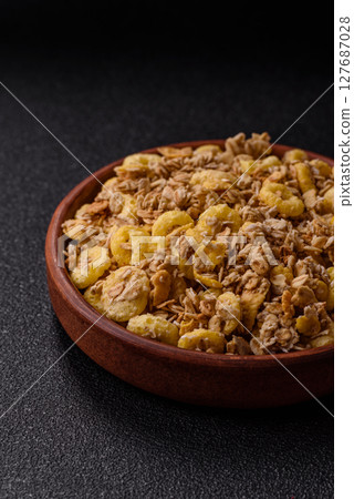 Flakes, chocolate balls and dried fruit for a hearty breakfast 127687028