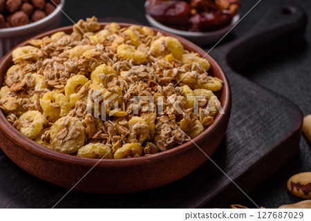 Flakes, chocolate balls and dried fruit for a hearty breakfast 127687029