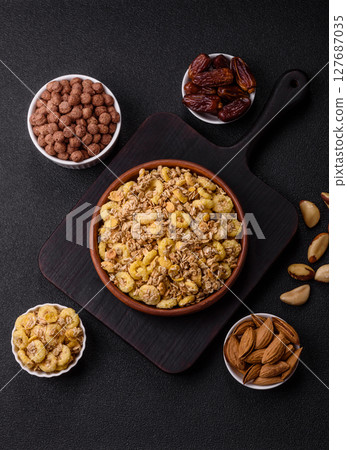 Flakes, chocolate balls and dried fruit for a hearty breakfast 127687035