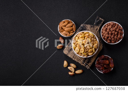 Flakes, chocolate balls and dried fruit for a hearty breakfast Flakes, chocolate balls and dried fruit for a hearty breakfast 127687038