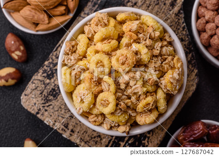 Flakes, chocolate balls and dried fruit for a hearty breakfast 127687042