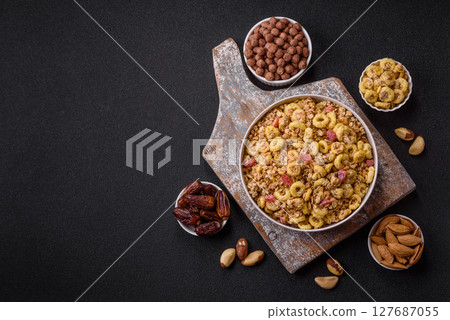 Flakes, chocolate balls and dried fruit for a hearty breakfast Flakes, chocolate balls and dried fruit for a hearty breakfast 127687055