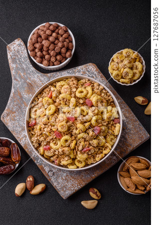 Flakes, chocolate balls and dried fruit for a hearty breakfast 127687056