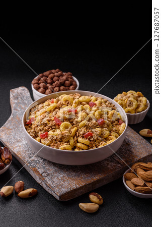 Flakes, chocolate balls and dried fruit for a hearty breakfast Flakes, chocolate balls and dried fruit for a hearty breakfast 127687057
