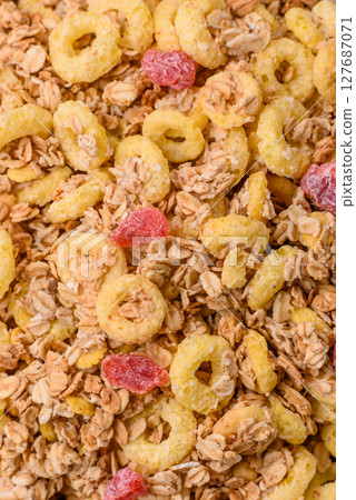 Flakes, chocolate balls and dried fruit for a hearty breakfast 127687071