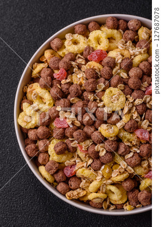 Flakes, chocolate balls and dried fruit for a hearty breakfast 127687078