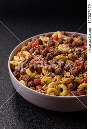 Flakes, chocolate balls and dried fruit for a hearty breakfast Flakes, chocolate balls and dried fruit for a hearty breakfast 127687079