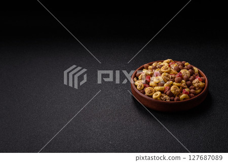 Flakes, chocolate balls and dried fruit for a hearty breakfast Flakes, chocolate balls and dried fruit for a hearty breakfast 127687089