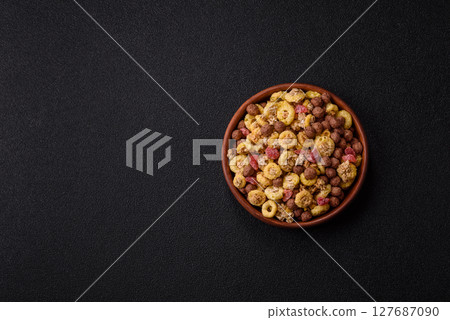 Flakes, chocolate balls and dried fruit for a hearty breakfast 127687090