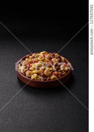 Flakes, chocolate balls and dried fruit for a hearty breakfast Flakes, chocolate balls and dried fruit for a hearty breakfast 127687092