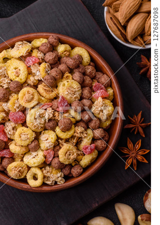 Flakes, chocolate balls and dried fruit for a hearty breakfast Flakes, chocolate balls and dried fruit for a hearty breakfast 127687098