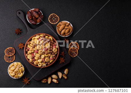 Flakes, chocolate balls and dried fruit for a hearty breakfast Flakes, chocolate balls and dried fruit for a hearty breakfast 127687101