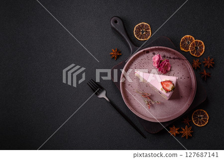 A slice of pink colored puff cake for a birthday celebration 127687141