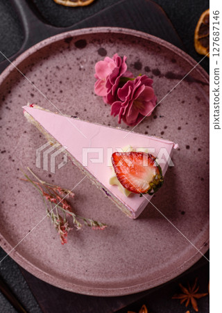 A slice of pink colored puff cake for a birthday celebration 127687146