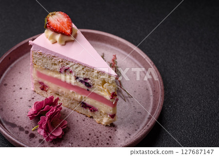 A slice of pink colored puff cake for a birthday celebration 127687147