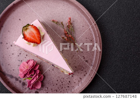 A slice of pink colored puff cake for a birthday celebration 127687148