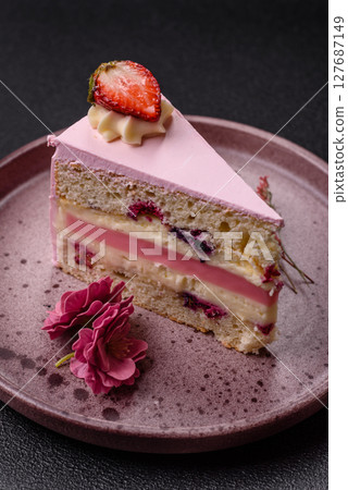 A slice of pink colored puff cake for a birthday celebration 127687149