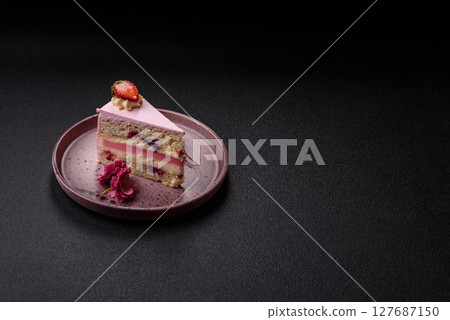 A slice of pink colored puff cake for a birthday celebration 127687150