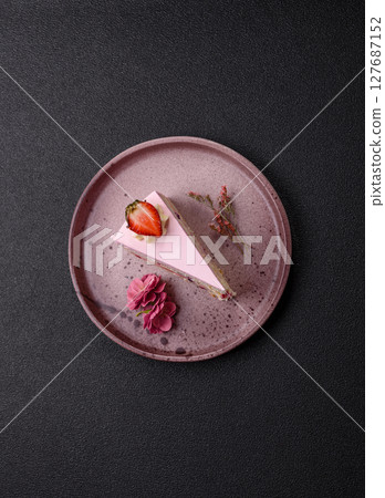 A slice of pink colored puff cake for a birthday celebration A slice of pink colored puff cake for a birthday celebration 127687152