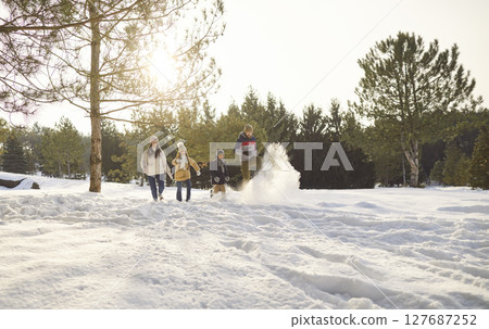 Happy smiling family with kids walking in winter park having fun with snow together in forest. 127687252