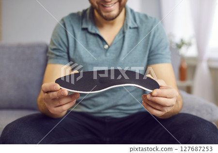 Positive Man Orthopedist Holding Shoe Insole Positive Man Orthopedist Holding Shoe Insole 127687253