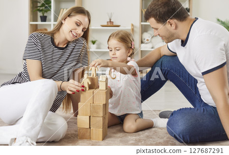 Happy friendly active family portrait at home enjoy playing carefully wood cube board game together 127687291
