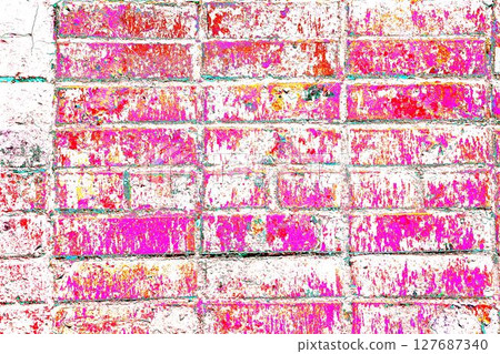 Peeling paint on a brick wall. Old brick wall with cracked peeling paint. 127687340