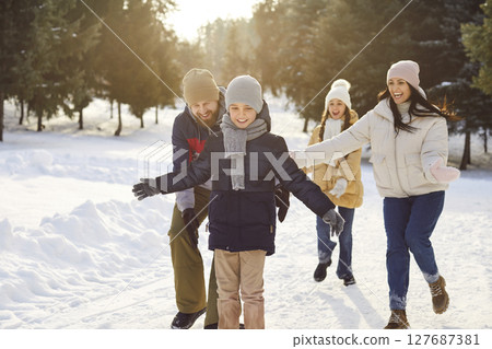 Happy family winter fun, vacation, spending weekend outdoor, parent, children enjoy holiday together Happy family winter fun, vacation, spending weekend outdoor, parent, children enjoy holiday together 127687381