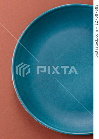 Empty ceramic plate on a monochrome brown background Empty ceramic plate on a monochrome brown background 127687685