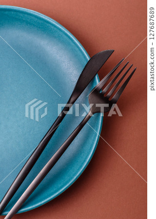 Empty ceramic plate on a monochrome brown background Empty ceramic plate on a monochrome brown background 127687689