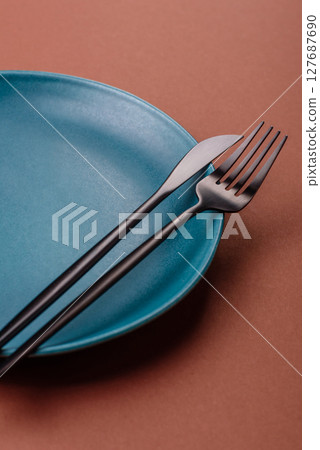 Empty ceramic plate on a monochrome brown background Empty ceramic plate on a monochrome brown background 127687690