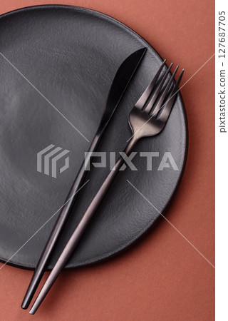 Empty ceramic plate on a monochrome brown background Empty ceramic plate on a monochrome brown background 127687705