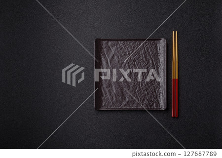 An empty plate with chopsticks for Japanese or Chinese food 127687789