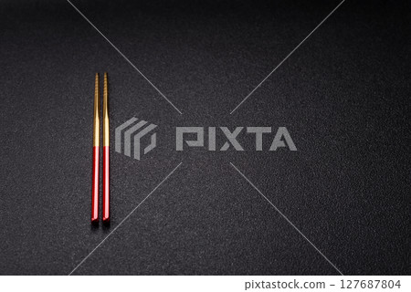 Stick or chopstick Japanese or Chinese for eating sushi, rolls Stick or chopstick Japanese or Chinese for eating sushi, rolls 127687804