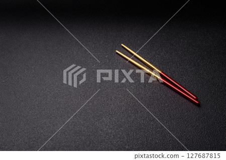 Stick or chopstick Japanese or Chinese for eating sushi, rolls 127687815