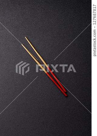 Stick or chopstick Japanese or Chinese for eating sushi, rolls Stick or chopstick Japanese or Chinese for eating sushi, rolls 127687817