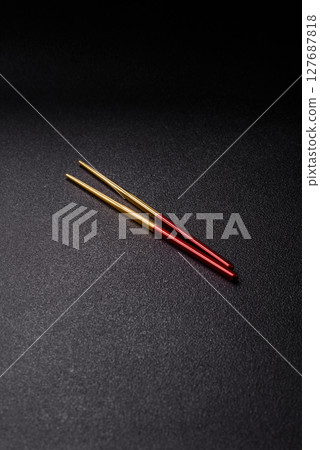 Stick or chopstick Japanese or Chinese for eating sushi, rolls Stick or chopstick Japanese or Chinese for eating sushi, rolls 127687818