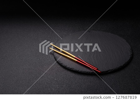 An empty plate with chopsticks for Japanese or Chinese food An empty plate with chopsticks for Japanese or Chinese food 127687819