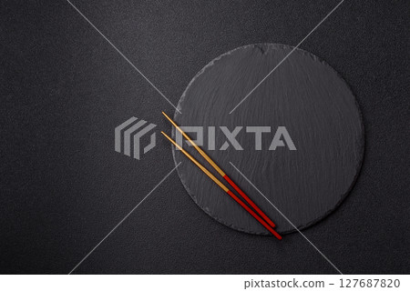An empty plate with chopsticks for Japanese or Chinese food 127687820