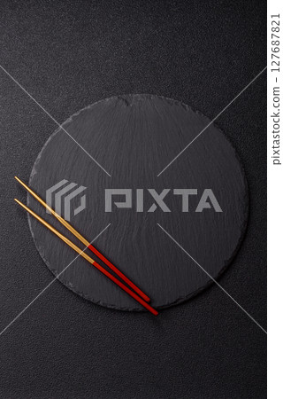 An empty plate with chopsticks for Japanese or Chinese food 127687821
