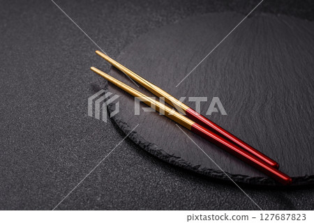 An empty plate with chopsticks for Japanese or Chinese food 127687823