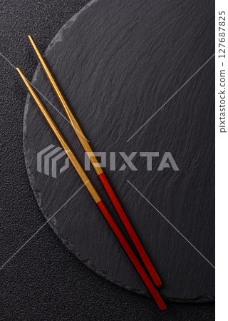An empty plate with chopsticks for Japanese or Chinese food An empty plate with chopsticks for Japanese or Chinese food 127687825