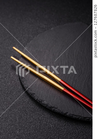 An empty plate with chopsticks for Japanese or Chinese food An empty plate with chopsticks for Japanese or Chinese food 127687826