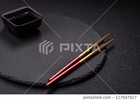 An empty plate with chopsticks for Japanese or Chinese food An empty plate with chopsticks for Japanese or Chinese food 127687827