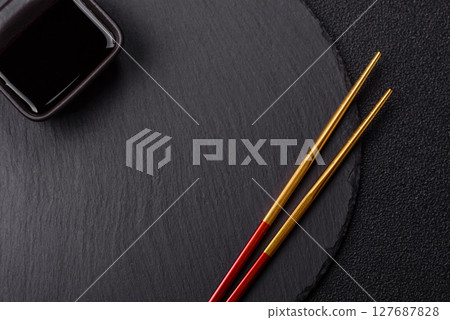 An empty plate with chopsticks for Japanese or Chinese food An empty plate with chopsticks for Japanese or Chinese food 127687828