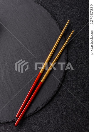 An empty plate with chopsticks for Japanese or Chinese food An empty plate with chopsticks for Japanese or Chinese food 127687829