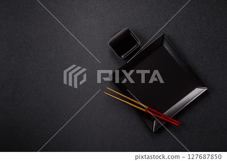 An empty plate with chopsticks for Japanese or Chinese food An empty plate with chopsticks for Japanese or Chinese food 127687850